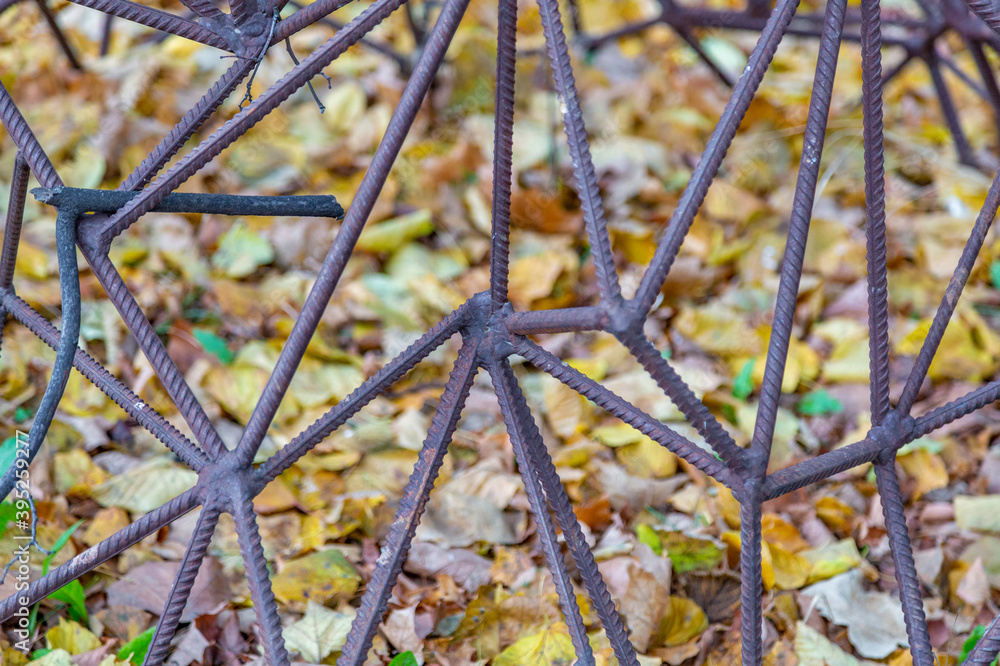 Abstract pattern of rusty rebar and yellow fallen leaves