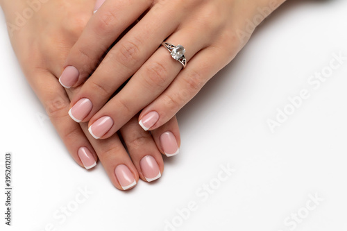 Wedding French manicure on short square nails. Ring on a finger. 