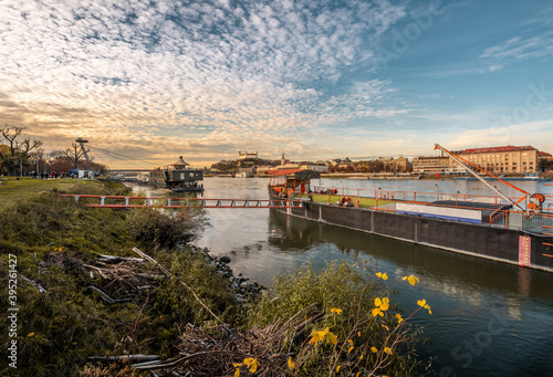 Bratislava cityscape on sunset with old boat on Danube river, Slovakia