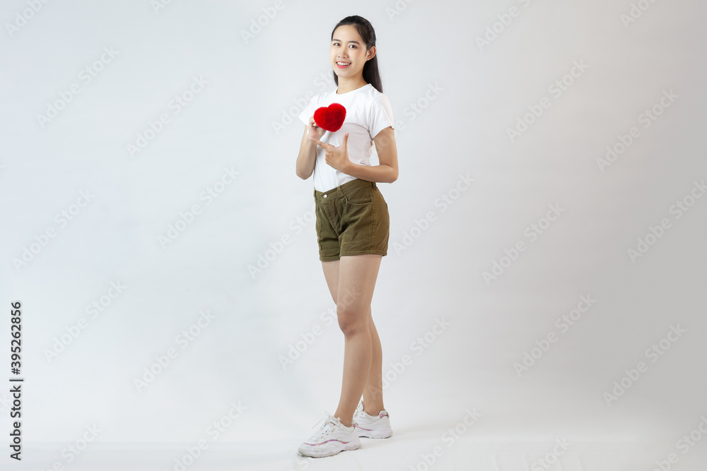 cute asia woman black long hair wearing white t-shirt and brown short pants with sneaker holding red heart standing on the white background
cute asia woman black long hair wearing white t-shirt and brown short pants with sneaker holding red heart standing on the white background