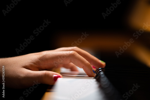 Hand of a girl playing the piano