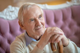 Elderly man sitting on the sofa and looking aside