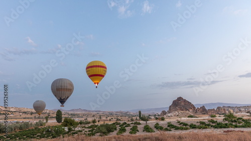 Beautiful colorful hot air balloons take off and flying in clear morning sky timelapse in Cappadocia, Turkey