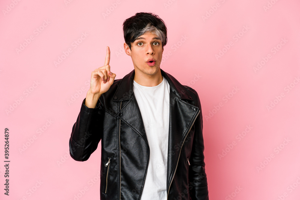 Young skinny hispanic man pointing upside with opened mouth. Young skinny hispanic man pointing upside with opened mouth.