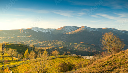 Sunset over the forests and villages from Doftana Valley in Romania at the bottom of Baiului Mountains in autumn landscape after a freezing day photo