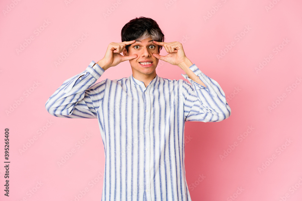 Young skinny hispanic man keeping eyes opened to find a success opportunity. Young skinny hispanic man keeping eyes opened to find a success opportunity.