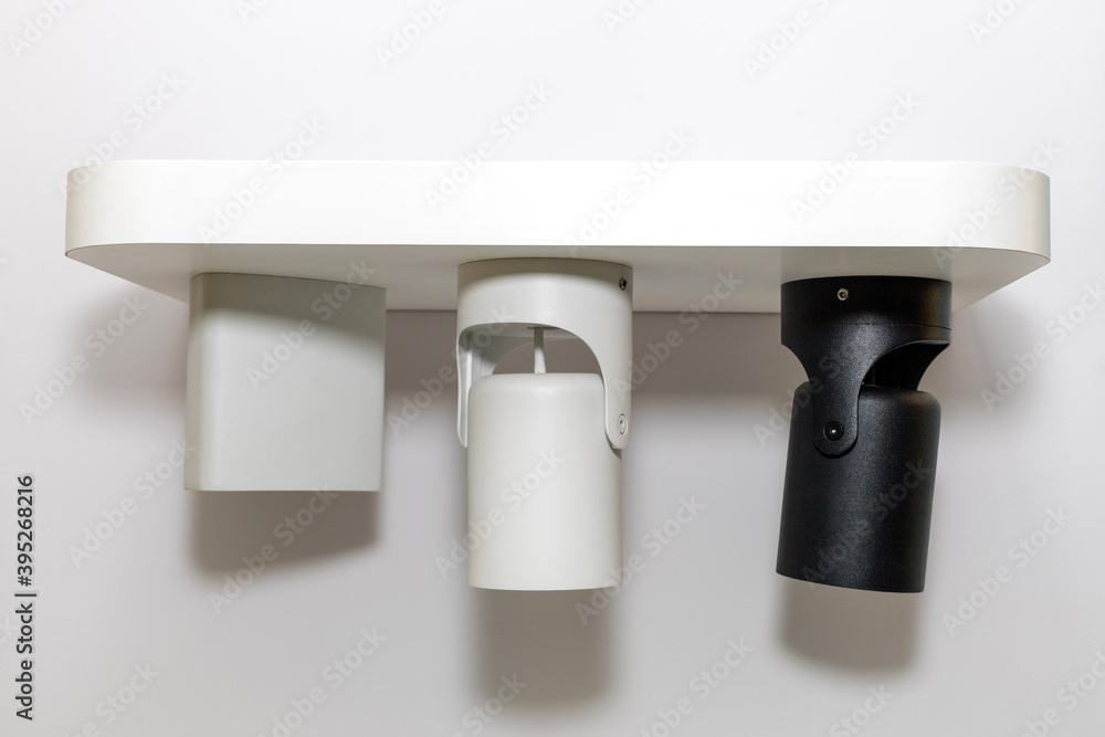 Three turned off modern metal led lamp on the white color wall. Free space. Three turned off modern metal led lamp on the white color wall. Free space.