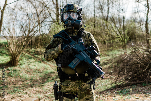 Croatian soldier wearing cropat uniform, protective gas mask M95 and carrying assault rifle G36