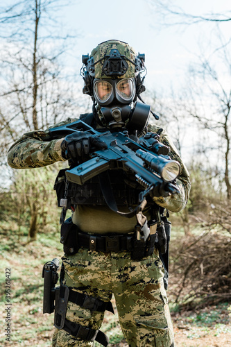 Croatian soldier in Cropat woodland uniform wearing gas mask M95 and assault rifle G36.