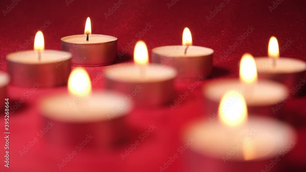 Candles tea lights in red background. Christmas, romantic Valentine's Day. Soft change of focus. Candles tea lights in red background. Christmas, romantic Valentine's Day. Soft change of focus.
