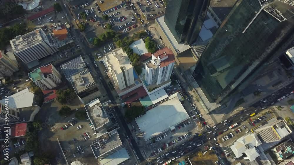 Descending aerial top down of high skyscraper building and traffic at 50th street during sunny day.Panama City. Descending aerial top down of high skyscraper building and traffic at 50th street during sunny day.Panama City.