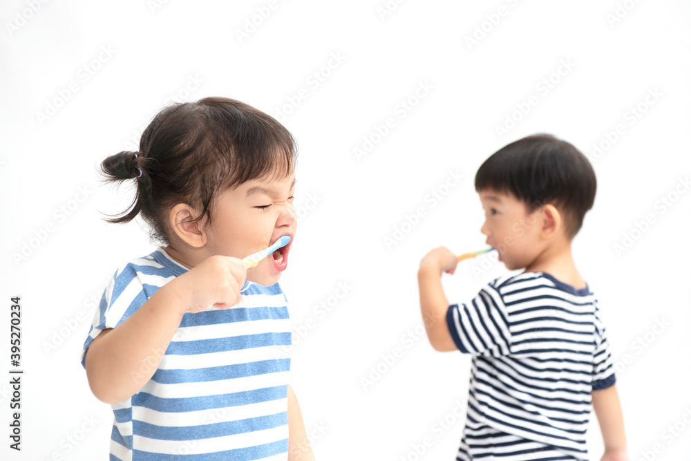 A little cute asian girl brushing her teeth isolated on white background. Healthy teeth concept. A little cute asian girl brushing her teeth isolated on white background. Healthy teeth concept.