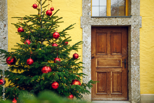 rustic back street Christmas tree and wooden poor entrance door empty back yard of town December winter holidays season © Артём Князь