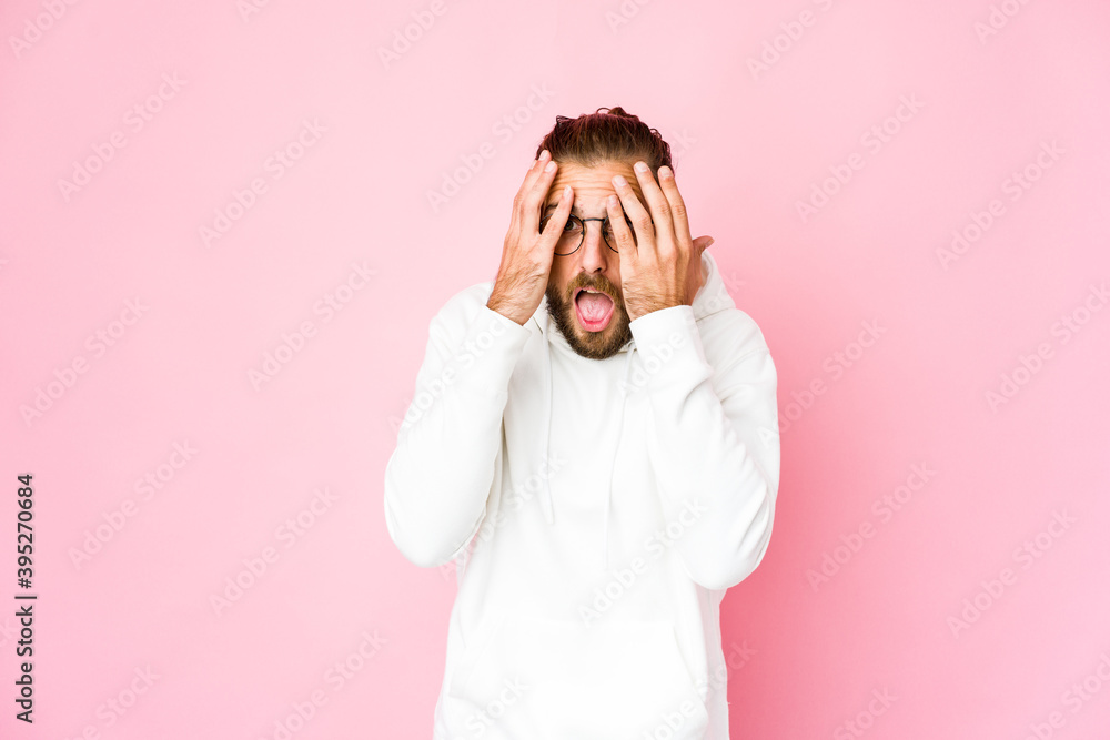 Young man with long hair look having fun covering half of face with palm. Young man with long hair look having fun covering half of face with palm.