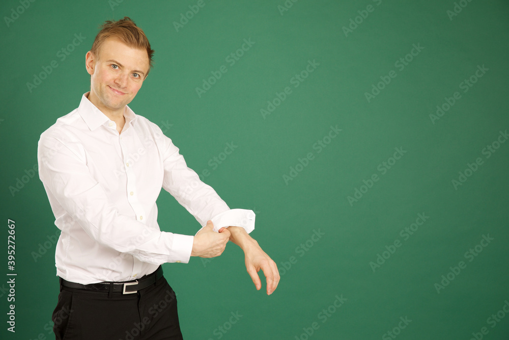 Attractive caucasian adult male wearing white suit and rolling up sleeves