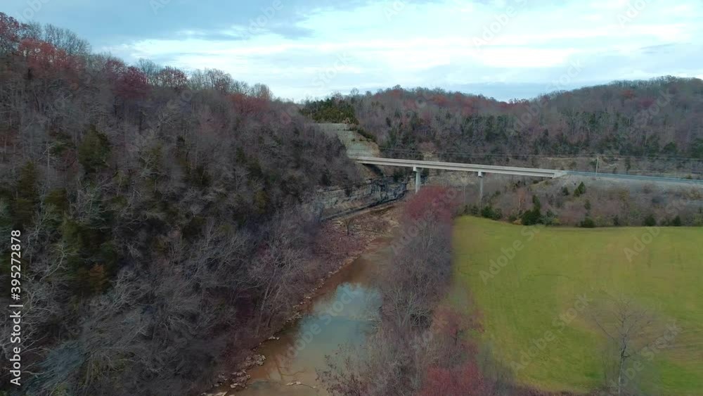 Aerial shot over Cedar Creek in Monterey Kentucky flying toward US 127 North bridge, beautiful fall scenery at sunset Aerial shot over Cedar Creek in Monterey Kentucky flying toward US 127 North bridge, beautiful fall scenery at sunset