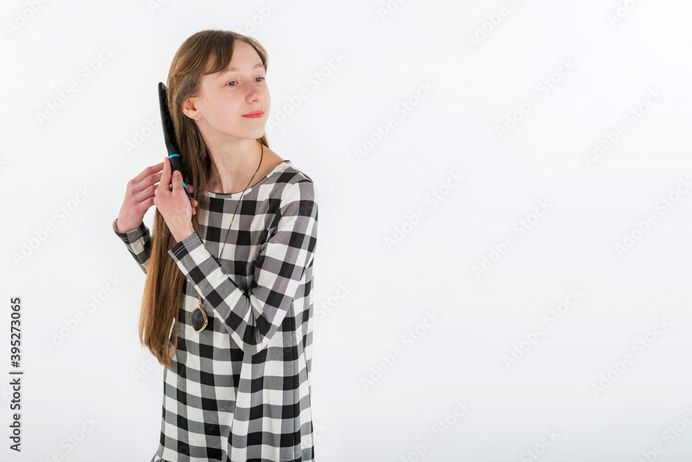 Closeup portrait girl brushing her hair on white.Copy space. Closeup portrait girl brushing her hair on white.Copy space.
