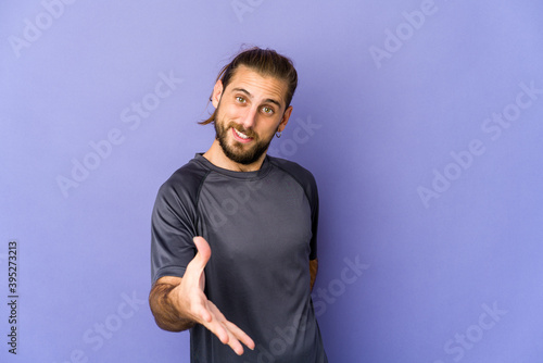 Bild auf Leinwand Young man with long hair look shocked covering mouth with hands.