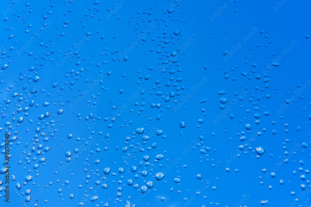 Water drops on the window after the rain, blue sky