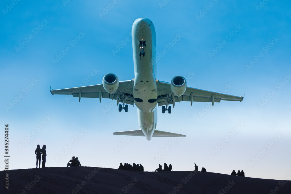 Jet aircraft low in flight, humans on the ground Jet aircraft low in flight, humans on the ground