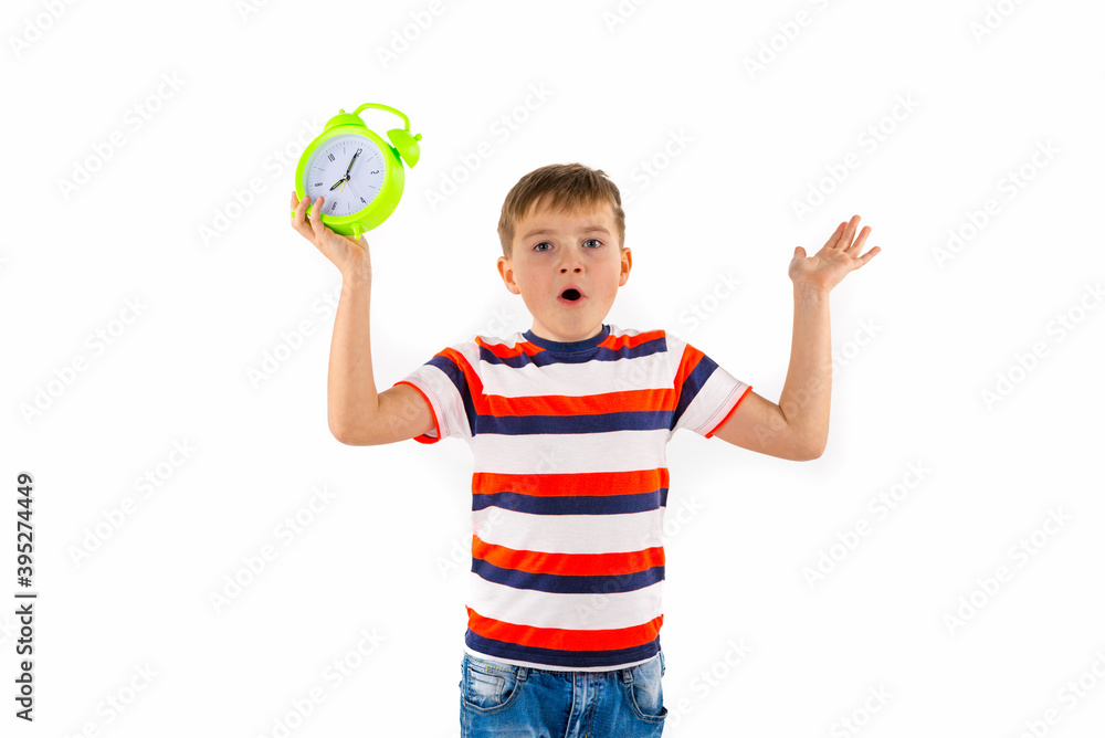 Upset cute boy holding alarm clock on white isolated background. Upset cute boy holding alarm clock on white isolated background.