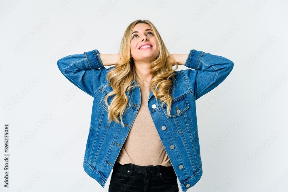Young caucasian blonde woman feeling confident, with hands behind the head. Young caucasian blonde woman feeling confident, with hands behind the head.