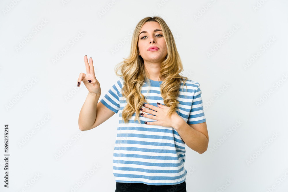 Fototapeta premium Young caucasian blonde woman taking an oath, putting hand on chest.