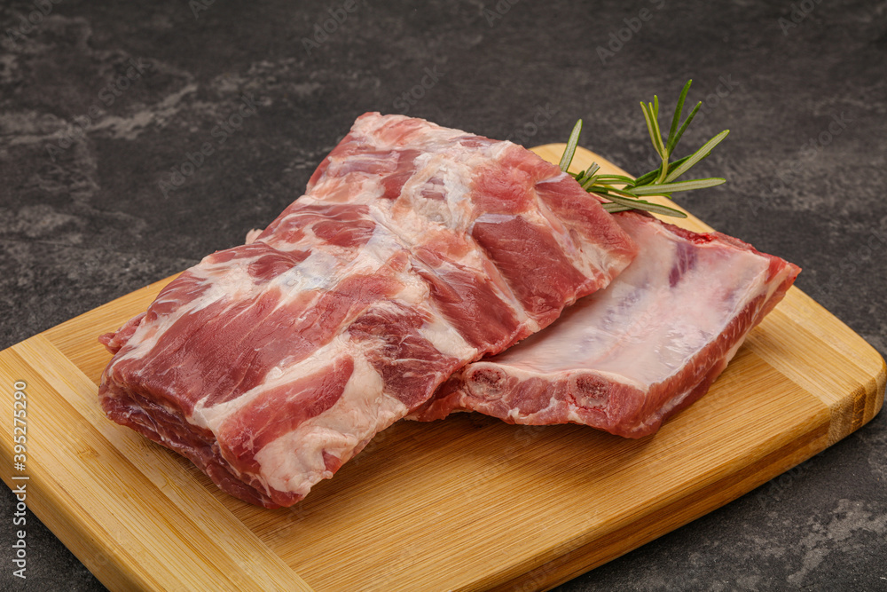 Raw pork ribs served rosemary