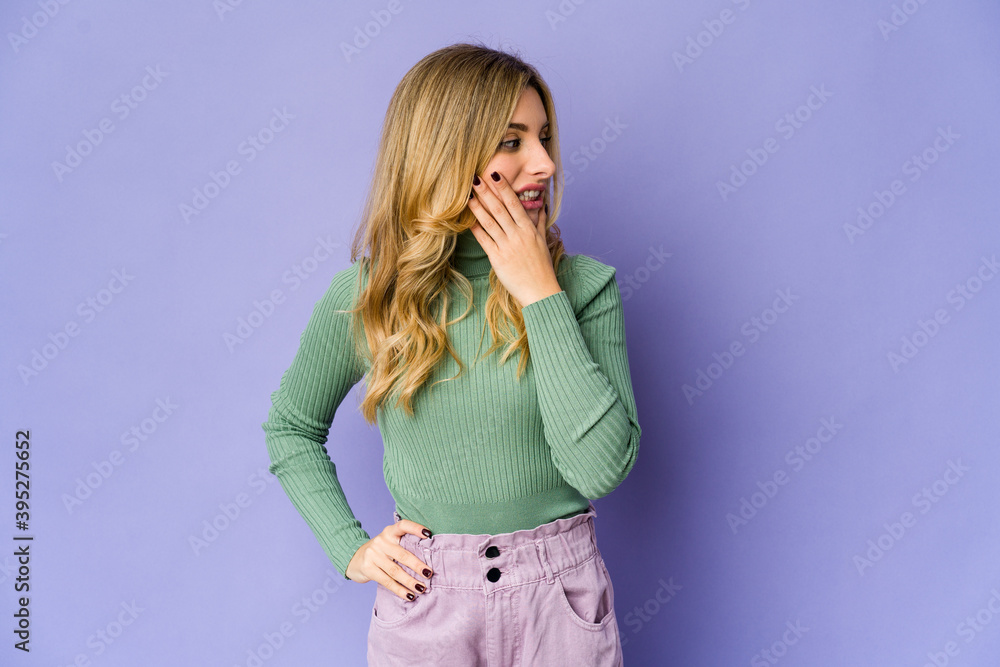 Young caucasian blonde woman touching back of head, thinking and making a choice. Young caucasian blonde woman touching back of head, thinking and making a choice.