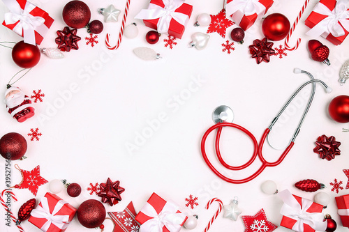 Red stethoscope with Christmas decoration and copy spacefor text on white background. photo