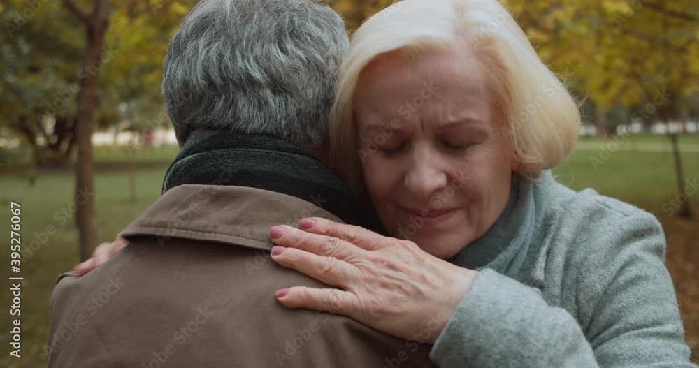 Blond woman hugging man, meeting old friend, couple reconnection, strong feeling Blond woman hugging man, meeting old friend, couple reconnection, strong feeling