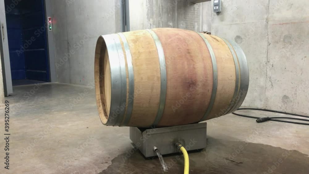 High pressure water used to clean the inside of a wooden wine barrel High pressure water used to clean the inside of a wooden wine barrel