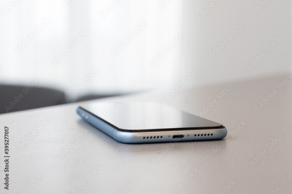 A single mobile phone on gray table A single mobile phone on gray table
