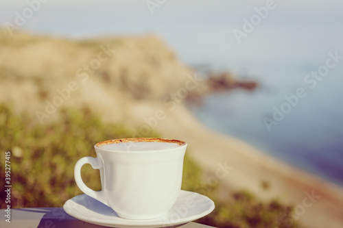 Coffe cup against sea beach.