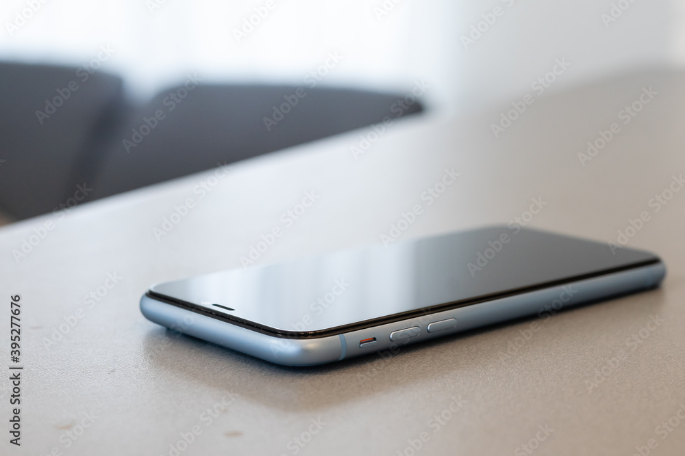 A single mobile phone on gray table A single mobile phone on gray table