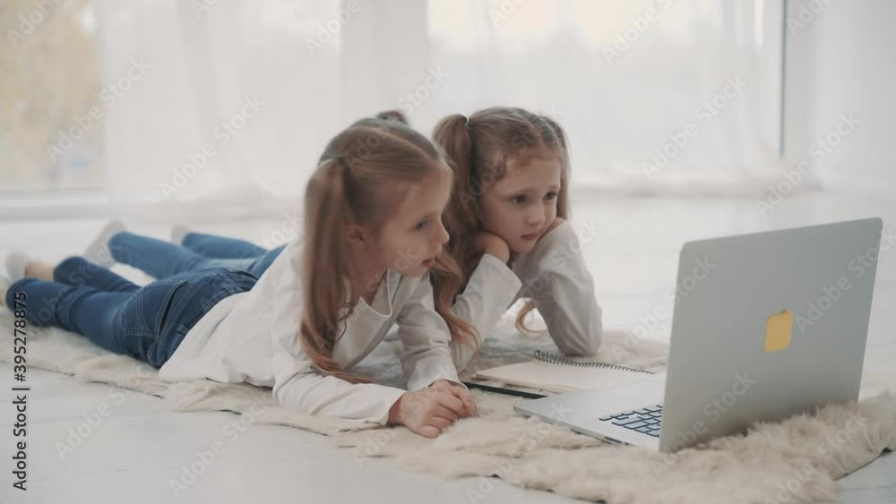 Distance learning. Little girls having a video call using laptop at home. Virtual classroom Distance learning. Little girls having a video call using laptop at home. Virtual classroom