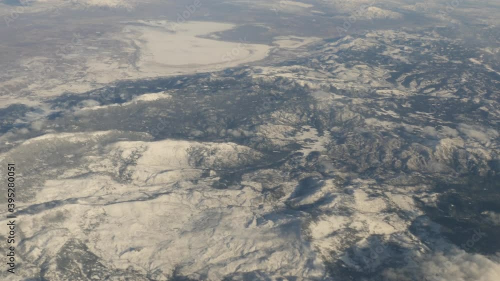 Aerial view of Oregon Snow Capped Mountains with clouds out of plane window shot in 4k high resolution Aerial view of Oregon Snow Capped Mountains with clouds out of plane window shot in 4k high resolution