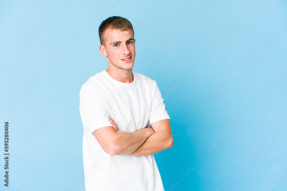 Young caucasian handsome man who feels confident, crossing arms with determination. Young caucasian handsome man who feels confident, crossing arms with determination.
