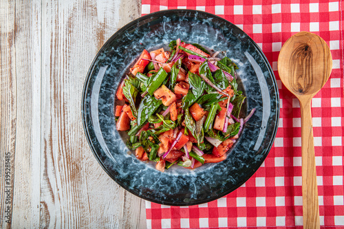 Tablaci Salad. They are indispensable flavors of Turkish cuisine. Especially with tomato and hot pepper sauce. Shepherd's salad, tomato salad and a great presentation. photo