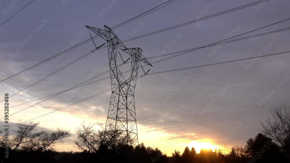 Electrical tower against a cloudy sky at sunset. Electrical tower against a cloudy sky at sunset.