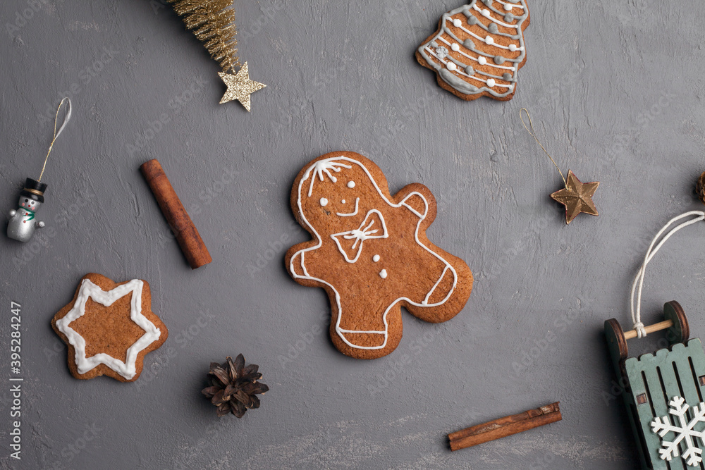 Christmas holidays ornament flat lay; Christmas card background. Gingerbread cookie, christmas toys on gray background