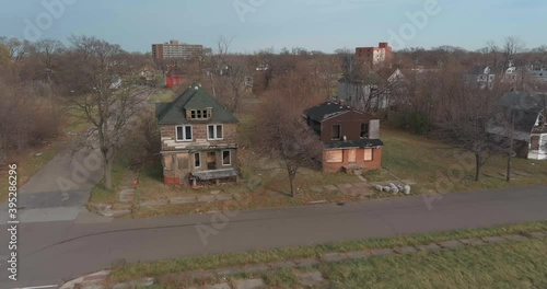 Aerial view of dilapidated house in a neighborhood in the city of Detroit, Michigan. This video was filmed in 4k for best image quality. photo