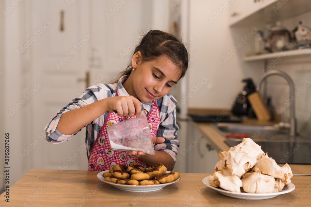 Girl cooked cookies for celebrate Christmas in kitchen at home. Merry Christmas and Happy New Year. Cooking and Holiday concept. Copy space Girl cooked cookies for celebrate Christmas in kitchen at home. Merry Christmas and Happy New Year. Cooking and Holiday concept. Copy space