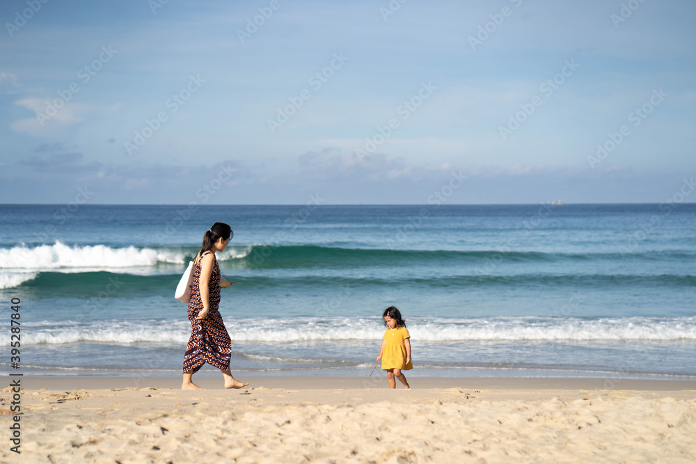 Mother and daughter walking at sea shore in Phuket Thailand. Mother and daughter walking at sea shore in Phuket Thailand.