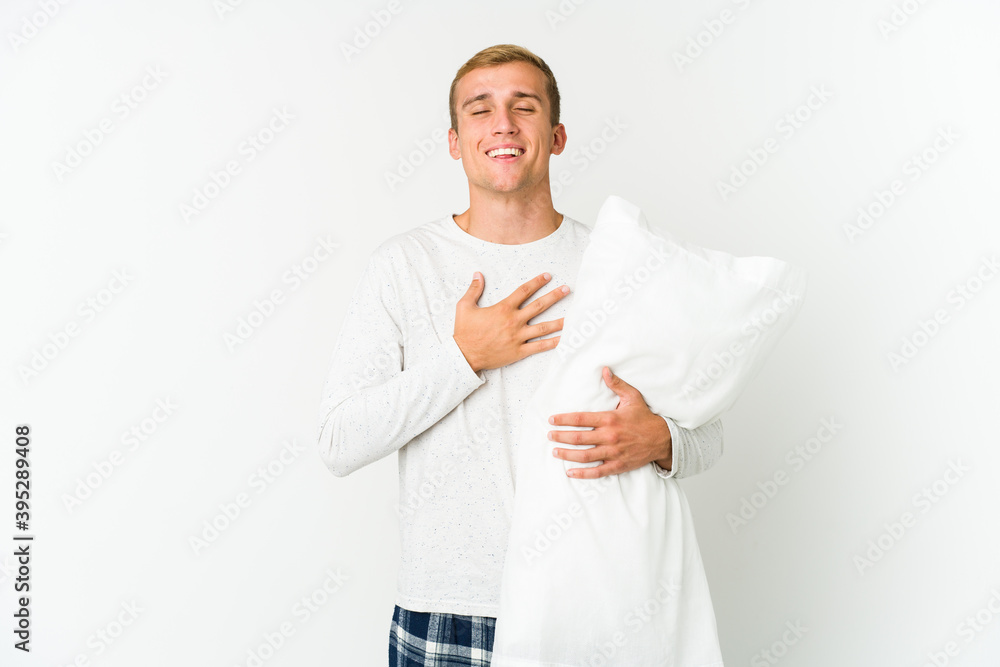 Young caucasian man going to sleep isolated on white background Young caucasian man going to sleep isolated on white background