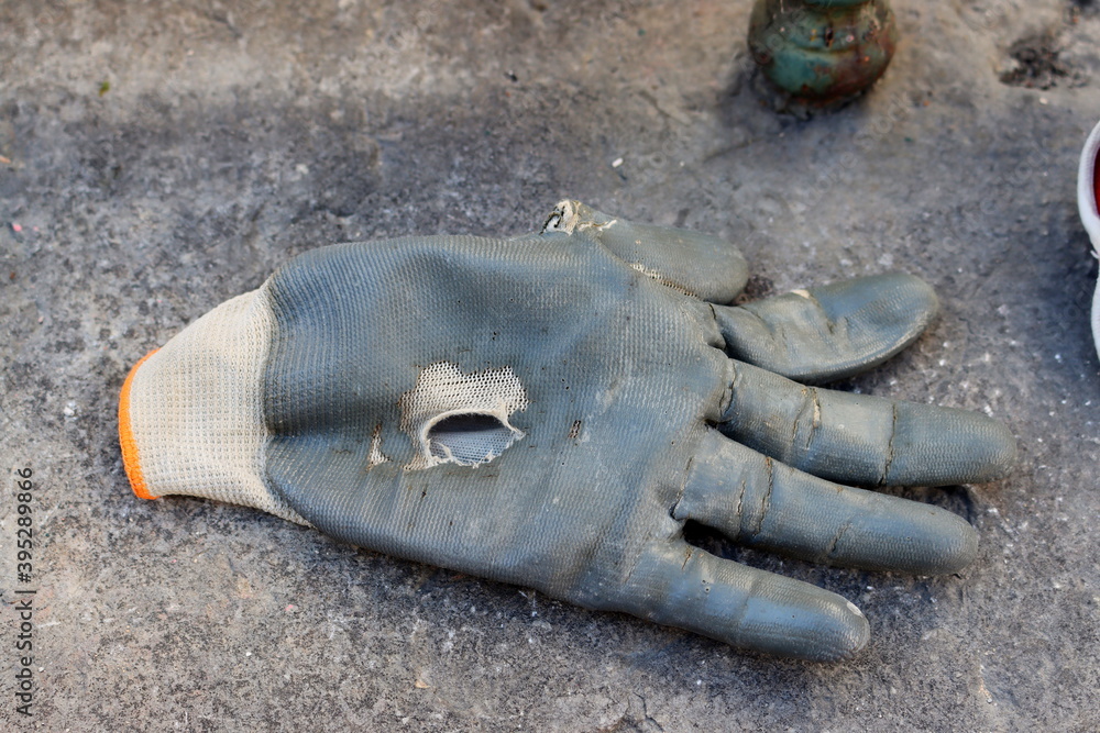 Holey working gloves at a construction site.