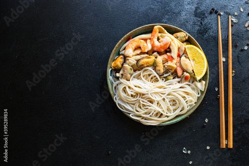 rice noodles cellophane pasta seafood shrimp, mussels, squid healthy meal snack top view copy space for text food background rustic