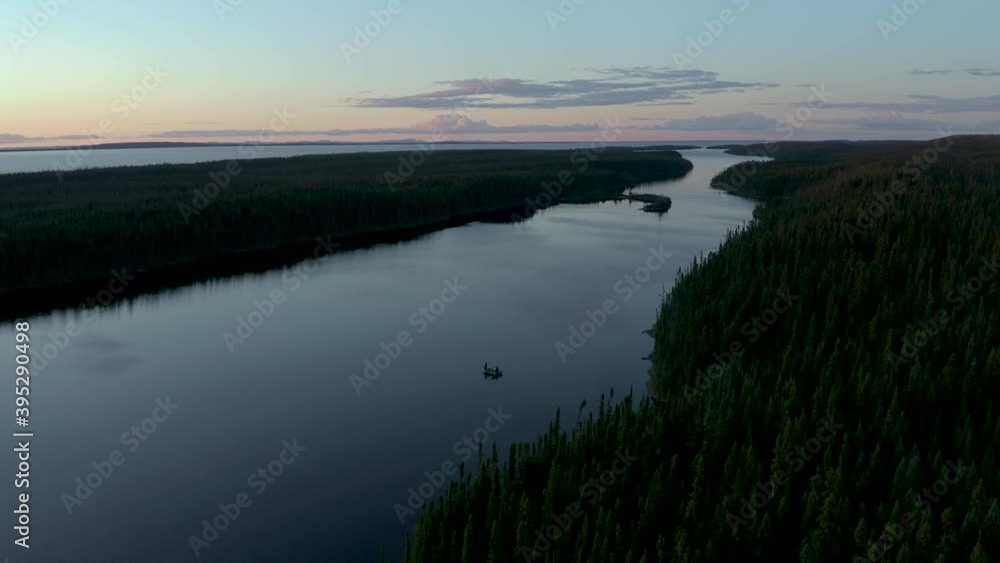 Drone flying around a lonely fishing boat on a huge lake with a beautiful sunset Drone flying around a lonely fishing boat on a huge lake with a beautiful sunset