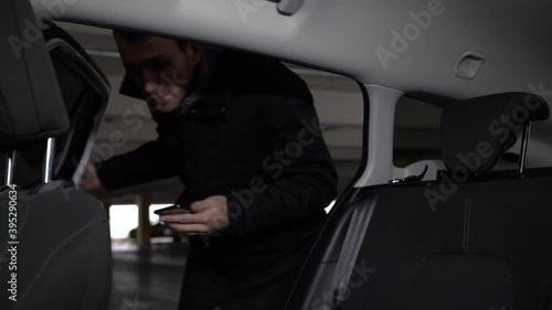 Taxi client getting into the car at the underground parking