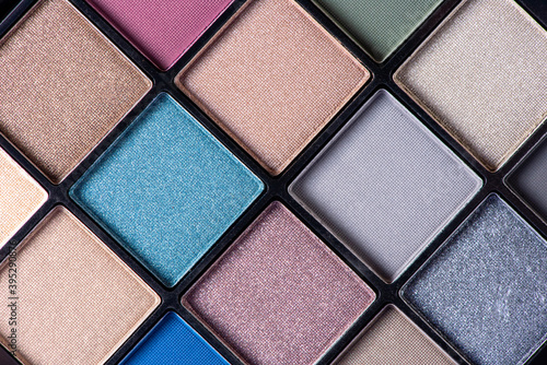 Palette of different beautiful colors of eye shadow closeup. Macro photography of makeup cosmetics